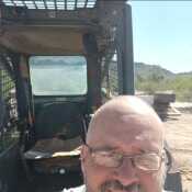 Me standing in front of my skid steer 