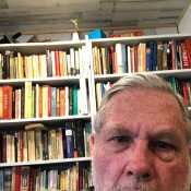 at my desk with part of my library behind me
