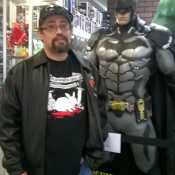I'm the one on the left, Batman on the RIGHT is a STATUE.
